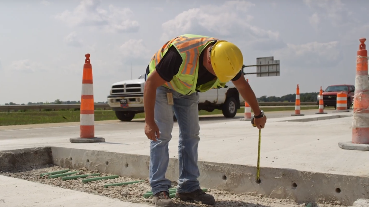 An engineering technician measuring the thickness of concrete.
